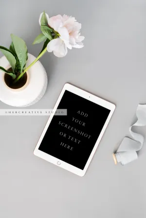 Tablet and Peony on Grey Background. Stock Image